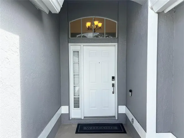 a view of a hallway view with wooden floor and staircase