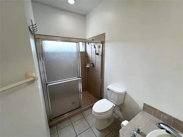 a bathroom with a granite countertop toilet and a shower
