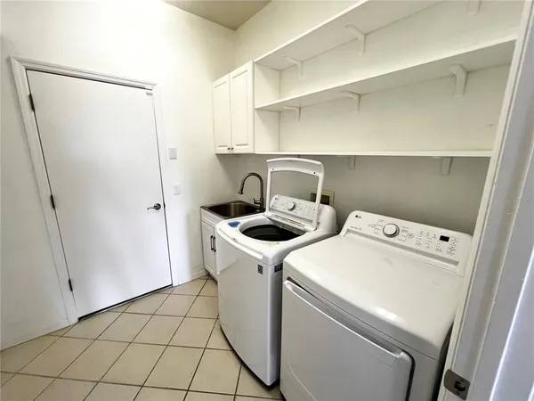 a view of a hallway with a large window and chandelier