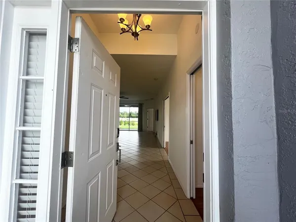a view of a hallway with wooden shelves