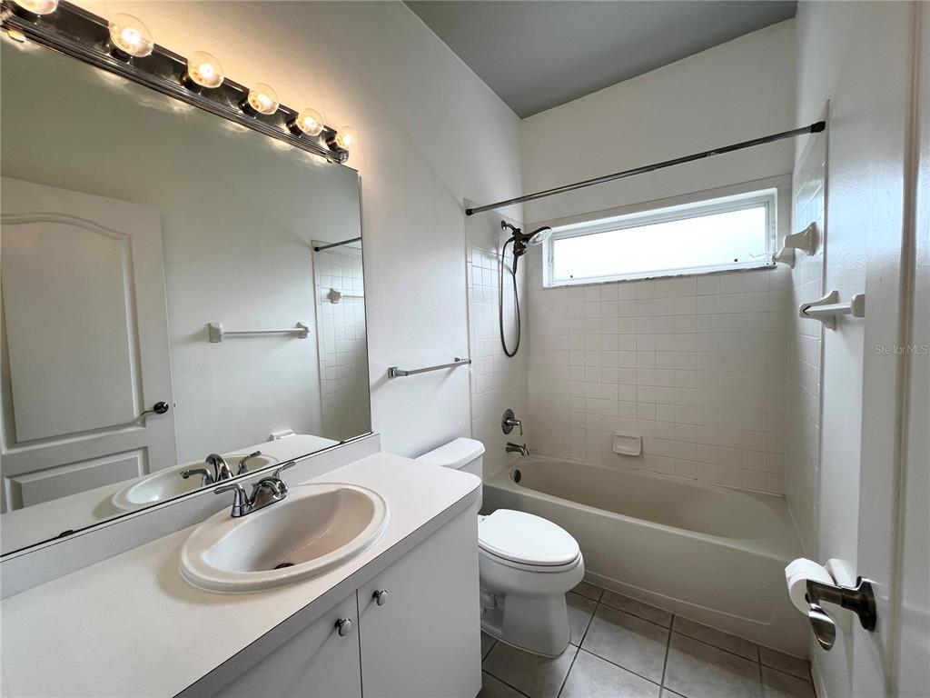 7463 Ridge Road Sarasota, FL 34238 - Photo 10 of 30 a bathroom with a sink a toilet and shower