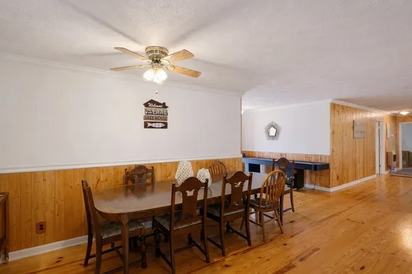 a view of a dining room with furniture and wooden floor