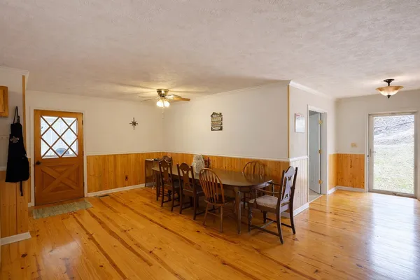 a view of a dining room with furniture and wooden floor