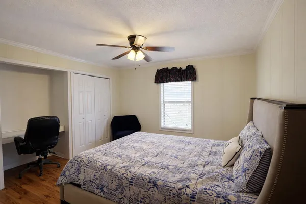 a bedroom with a bed and a chair