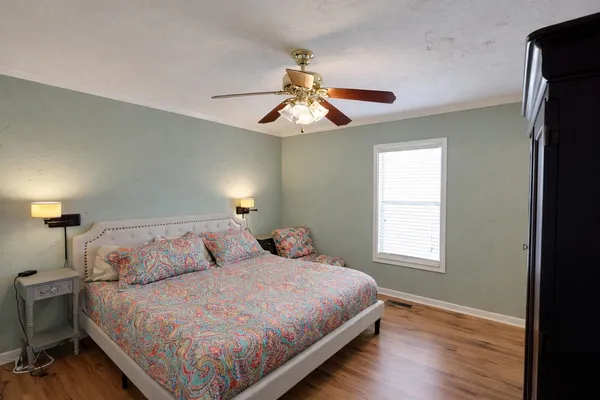 a bedroom with a bed and a window