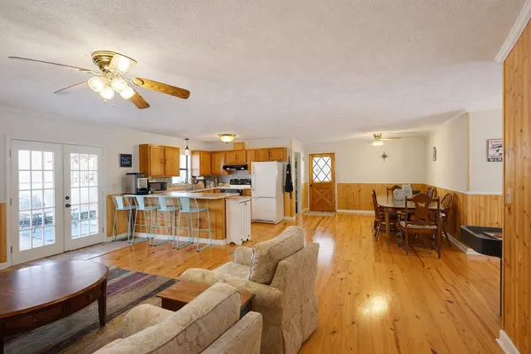 a living room with furniture and kitchen view