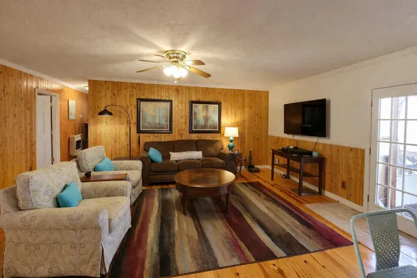 a living room with furniture and a flat screen tv
