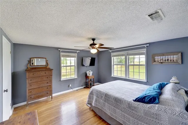 a bedroom with a bed dresser and a window