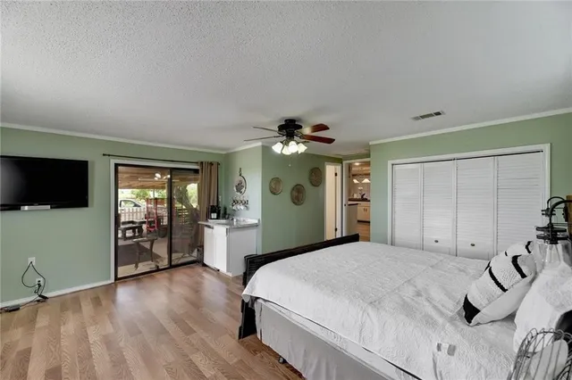 a bedroom with a large bed and a tv