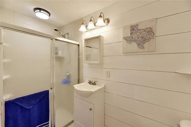 a bathroom with a sink a mirror and a shower