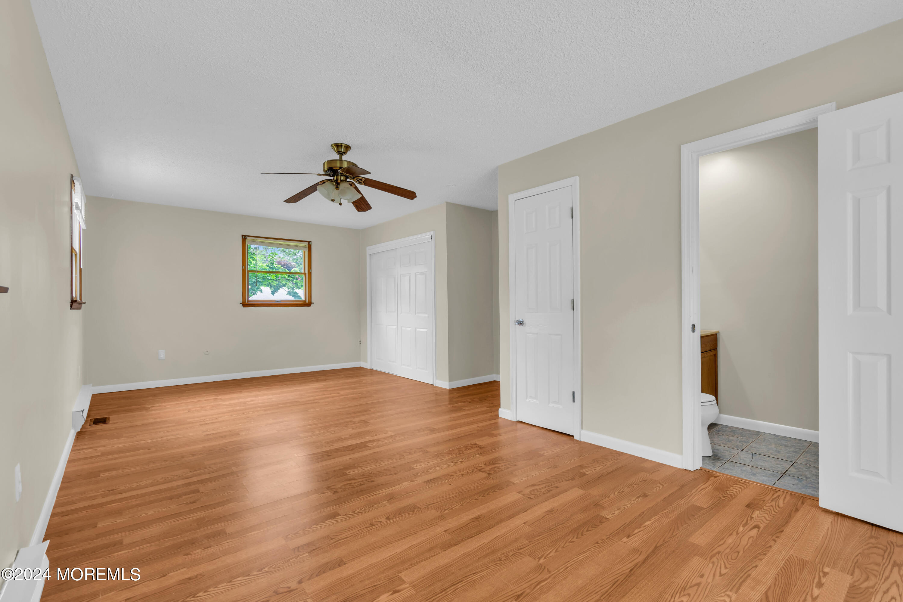 108 Jericho Road Tuckerton, NJ 08087 - Photo 16 of 24 wooden floor in an empty room with a window