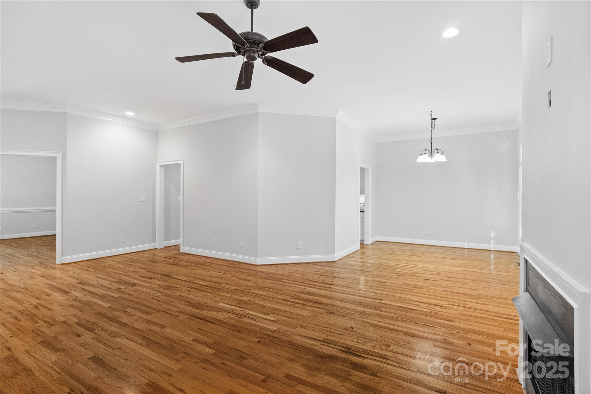 3310 Millstone Creek Road Lancaster, SC 29720 - Photo 11 of 45 a view of an empty room with wooden floor and a ceiling fan