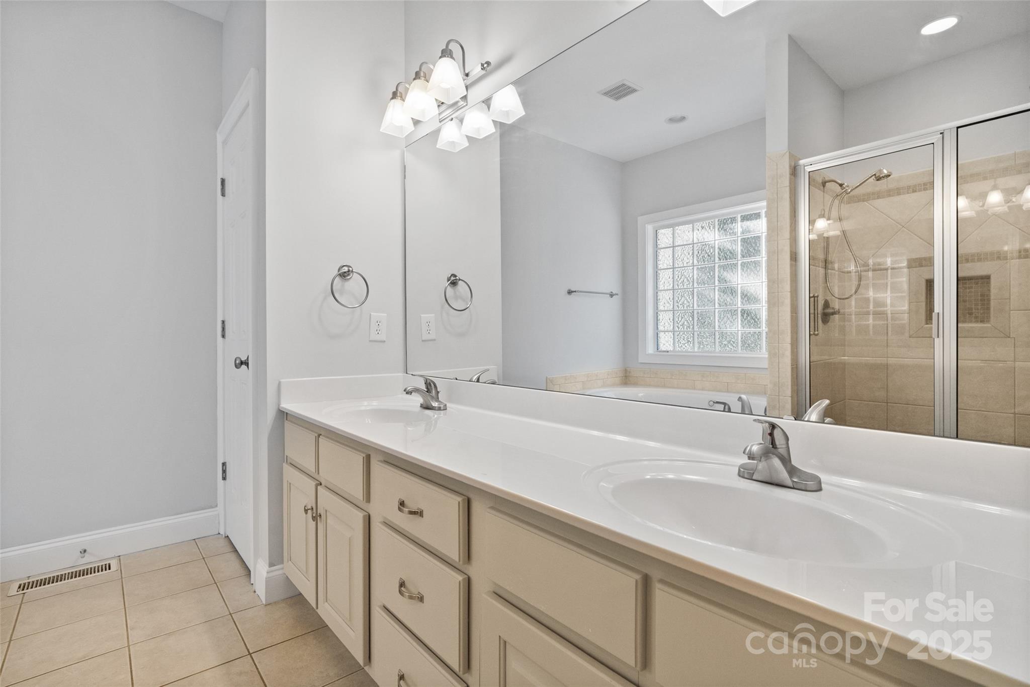 3310 Millstone Creek Road Lancaster, SC 29720 - Photo 21 of 45 a bathroom with double vanity sink a mirror a bathtub and shower