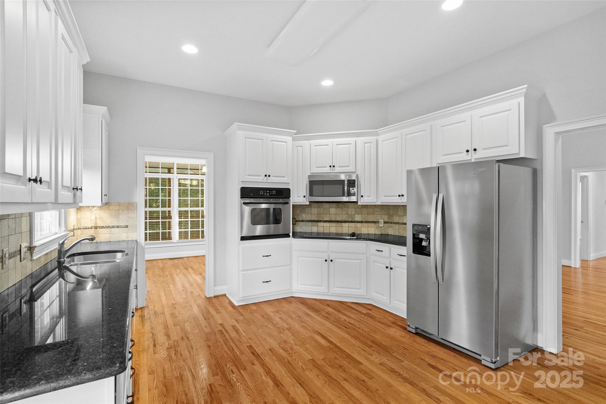 3310 Millstone Creek Road Lancaster, SC 29720 - Photo 5 of 45 a kitchen with granite countertop a refrigerator stove top oven and sink