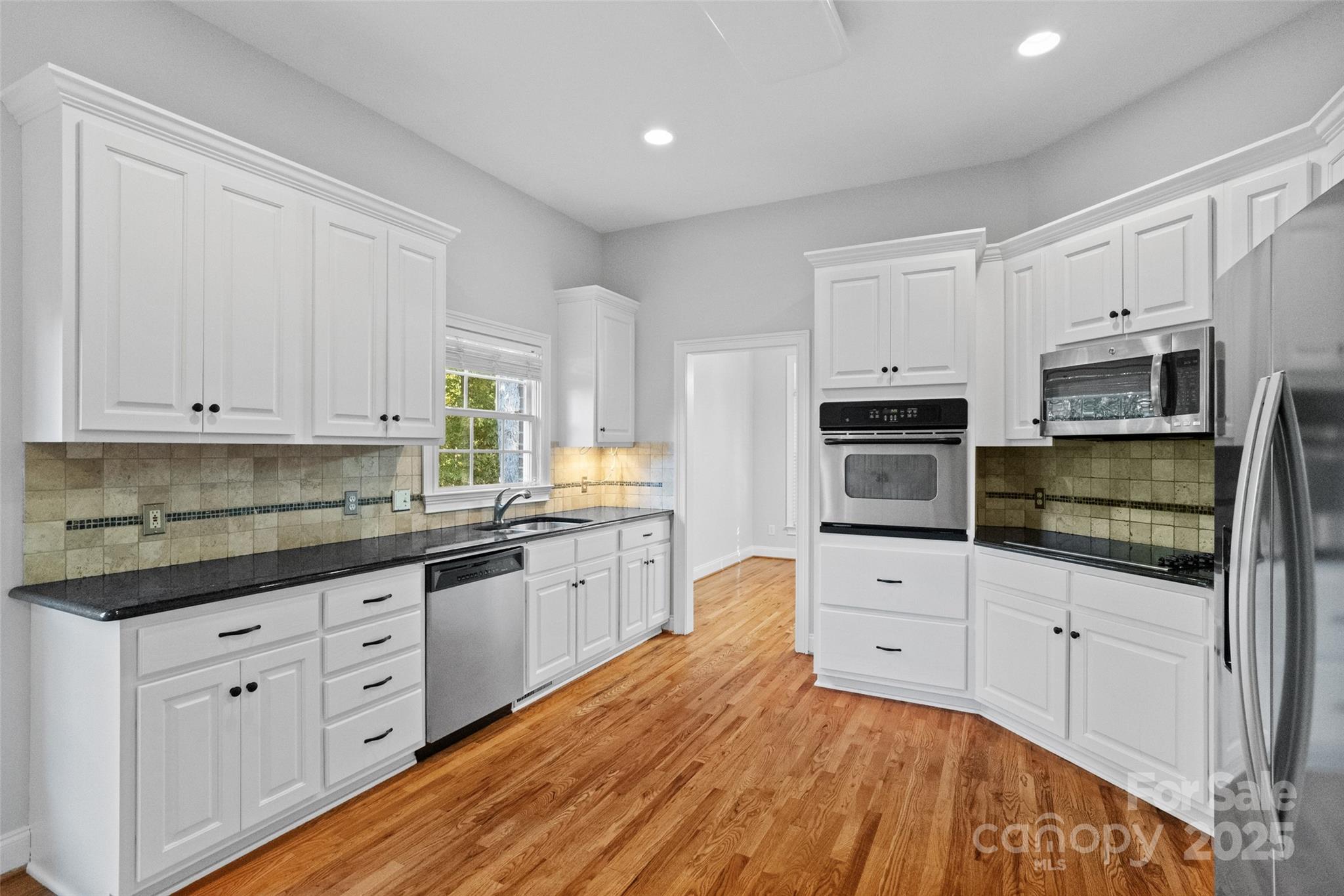 3310 Millstone Creek Road Lancaster, SC 29720 - Photo 6 of 45 a kitchen with granite countertop white cabinets and stainless steel appliances