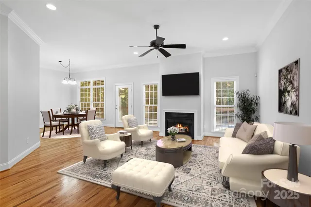 a living room with furniture a fireplace and a flat screen tv