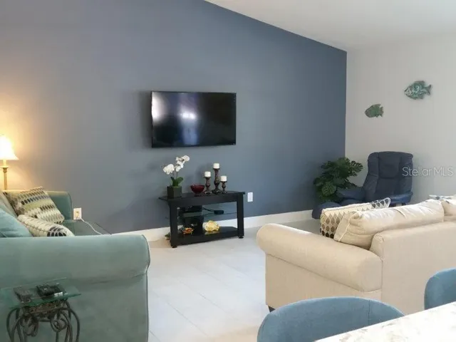 a living room with furniture and a flat screen tv