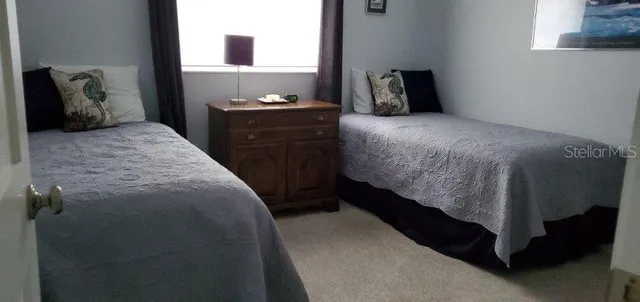 a bedroom with a bed and dresser