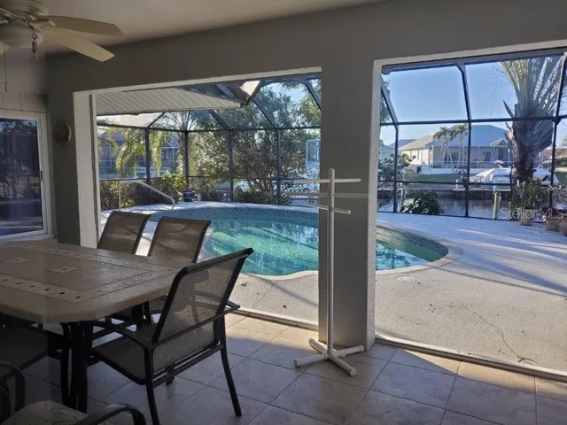 a view of a patio with table and chairs