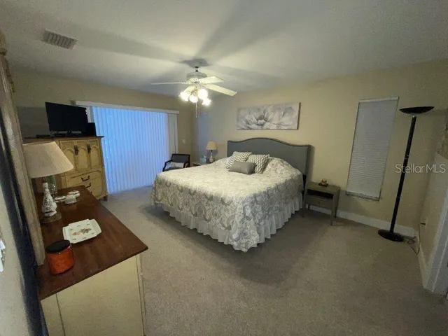 a bedroom with bed and a chandelier