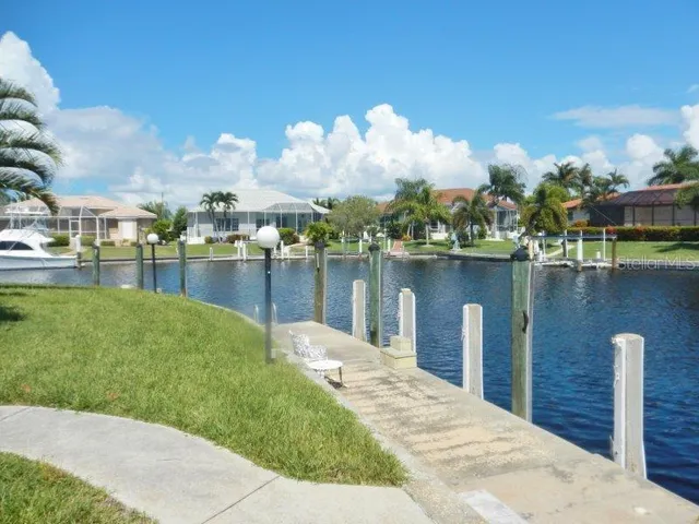a swimming pool with outdoor seating and lake view