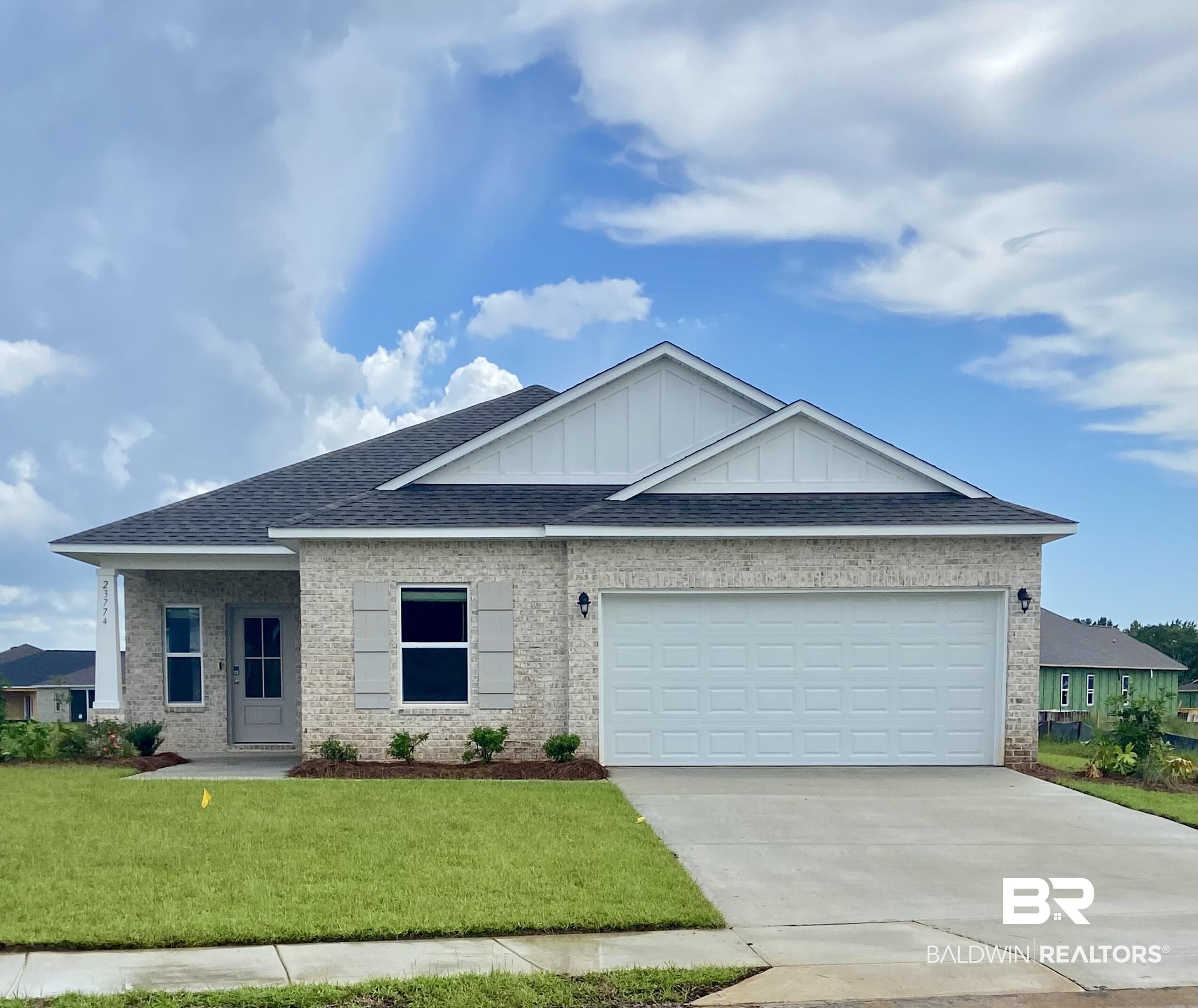 23774 Dominus Drive Daphne, AL 36526 - Photo 1 of 1 View of front of property with a garage and a front yard