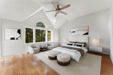 a bedroom with a large bed and a large window