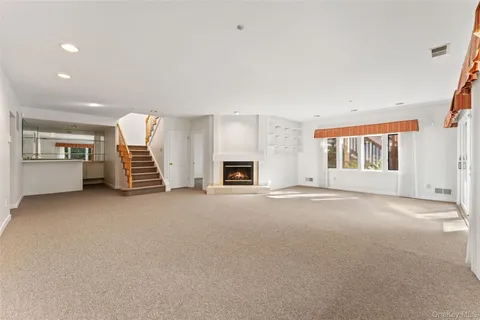 an empty room with furniture and a fireplace