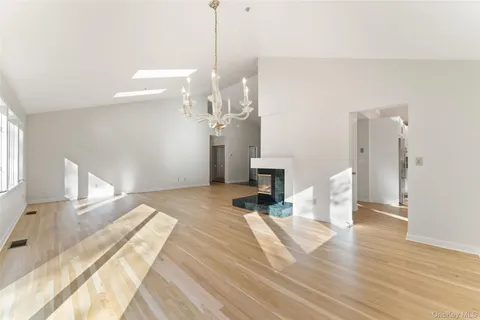 a view of a room with wooden floor and staircase
