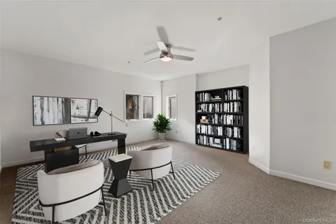 a living room with furniture a rug and a window