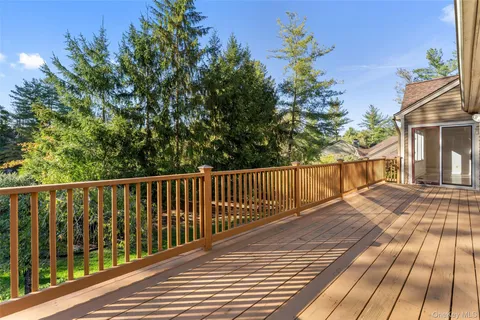 a balcony with wooden floor and fence