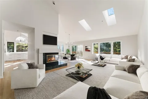 a living room with furniture fireplace and a large window
