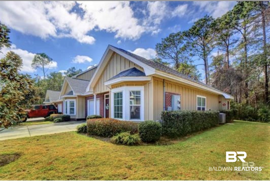 430 West Fort Morgan Road Gulf Shores, AL 36542 - Photo 2 of 27 Exterior featuring bay windows, vertical board and batten siding, brick accents, and a shingled roof