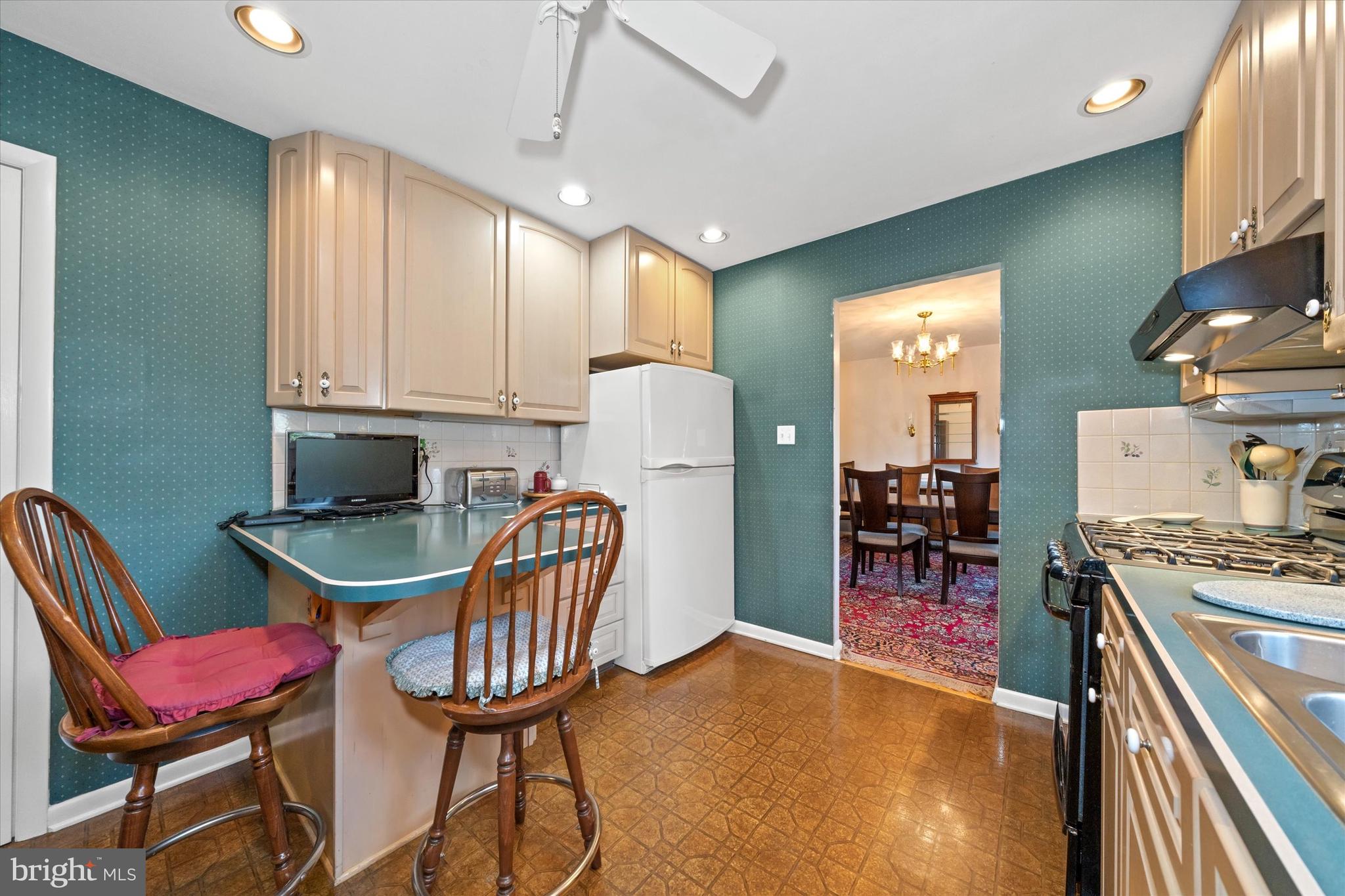 2605 Cayuga Road Wilmington, DE 19810 - Photo 15 of 53 a kitchen with stainless steel appliances kitchen island granite countertop a table chairs and a refrigerator