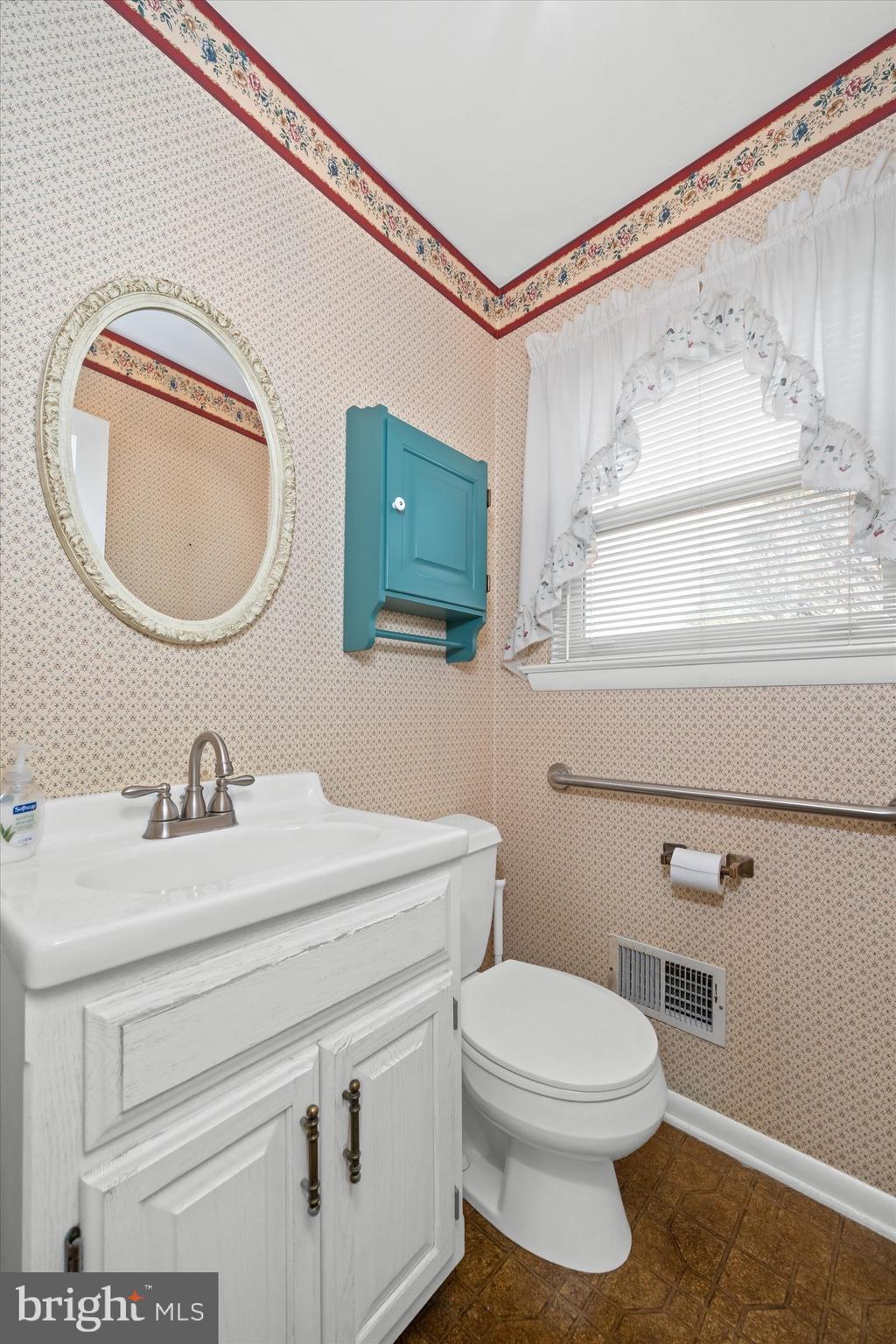 2605 Cayuga Road Wilmington, DE 19810 - Photo 19 of 53 a bathroom with a sink a toilet and a mirror