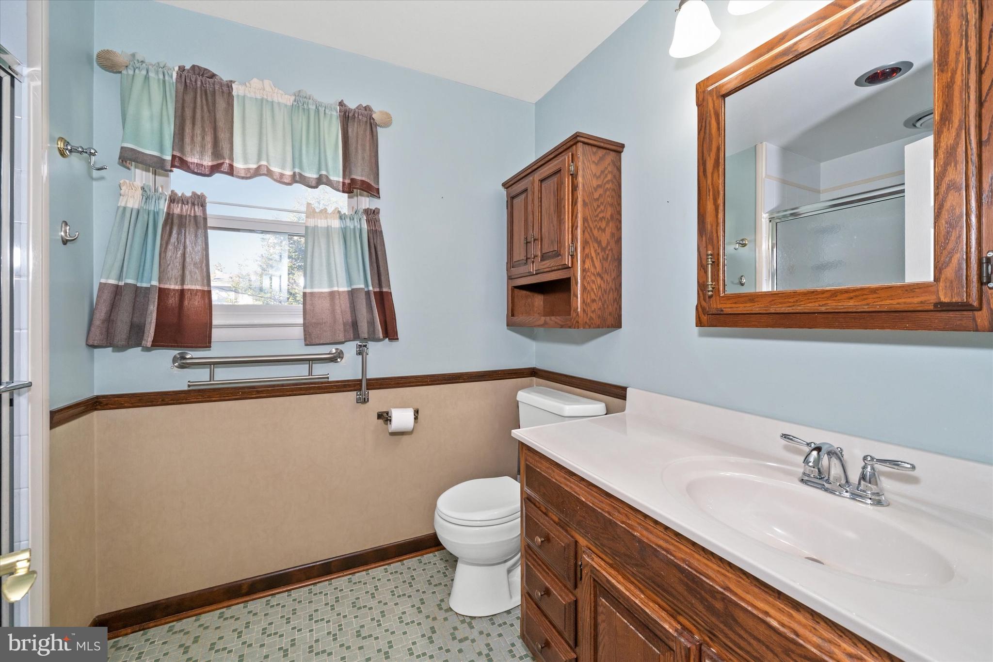 2605 Cayuga Road Wilmington, DE 19810 - Photo 34 of 53 a bathroom with a granite countertop toilet a sink and a mirror