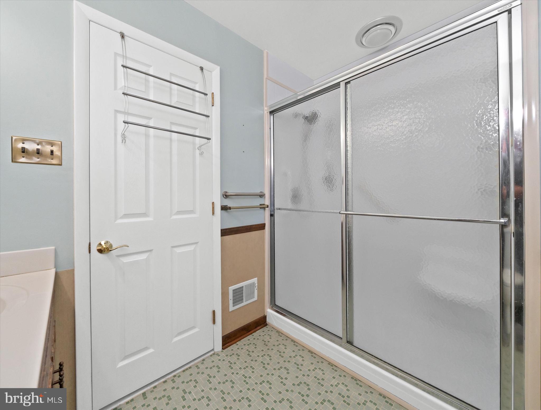 2605 Cayuga Road Wilmington, DE 19810 - Photo 35 of 53 a bathroom with a glass shower door