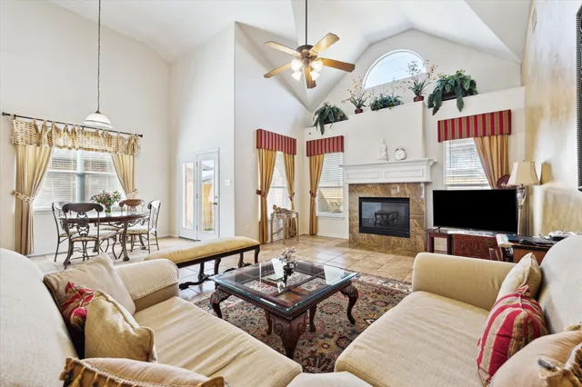 a living room with furniture a chandelier and a fireplace