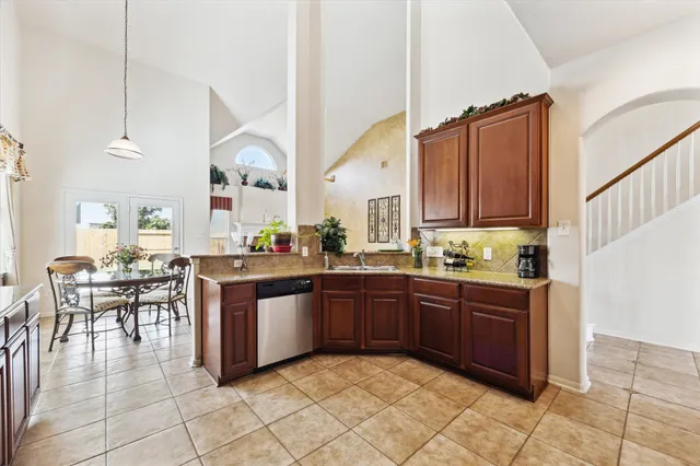 a kitchen with stainless steel appliances a refrigerator sink and stove