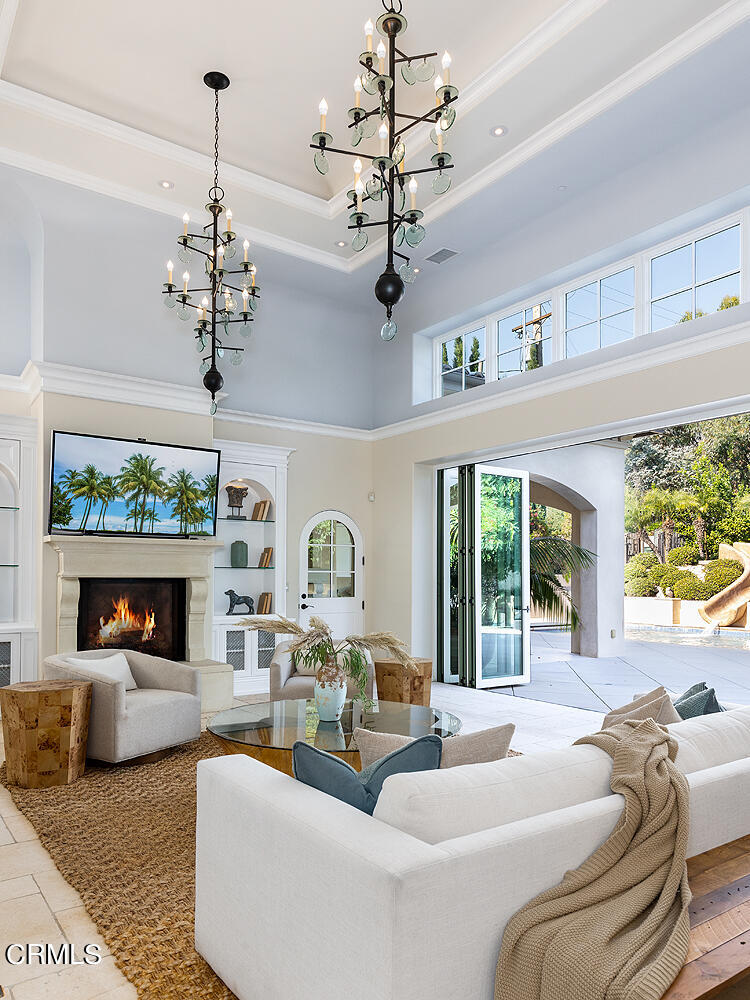 1610 Kinneloa Mesa Road Pasadena, CA 91107 - Photo 14 of 72 a living room with furniture a chandelier and a fireplace