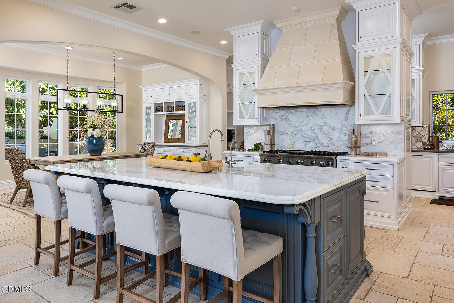 1610 Kinneloa Mesa Road Pasadena, CA 91107 - Photo 17 of 72 a kitchen with granite countertop a table chairs stove and cabinets