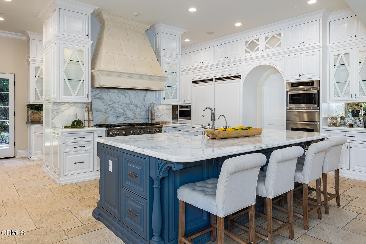 1610 Kinneloa Mesa Road Pasadena, CA 91107 - Photo 18 of 72 a kitchen with stainless steel appliances kitchen island granite countertop a table chairs sink and cabinets