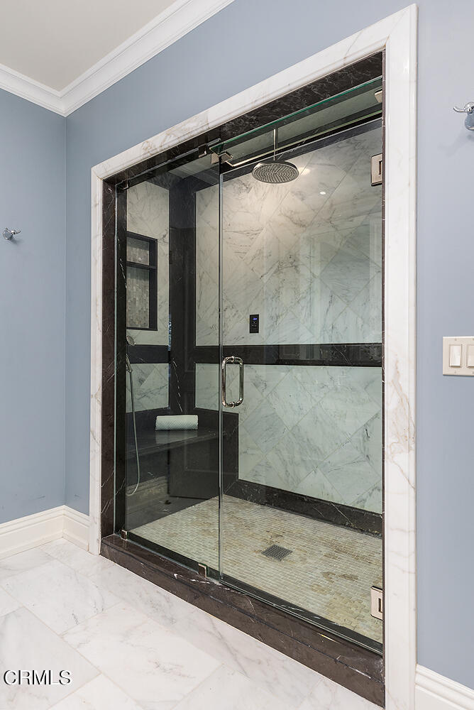 1610 Kinneloa Mesa Road Pasadena, CA 91107 - Photo 30 of 72 a bathroom with a glass shower door and a window