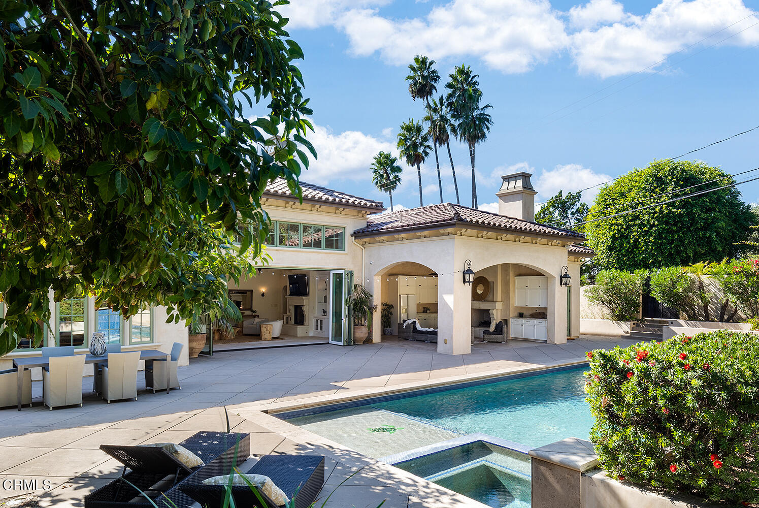1610 Kinneloa Mesa Road Pasadena, CA 91107 - Photo 64 of 72 a view of a white house with a swimming pool and lawn chairs