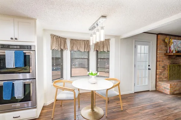 a view of a livingroom with furniture window and wooden floor