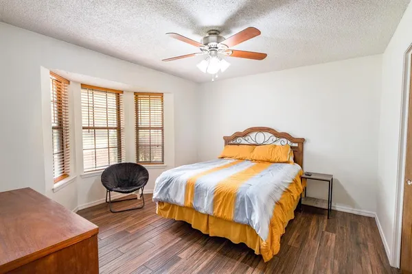 a bedroom with a bed a window and a chandelier