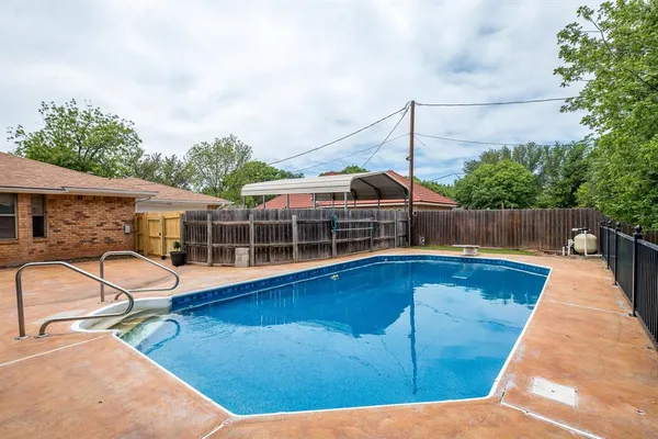 a view of a house with swimming pool and sitting area