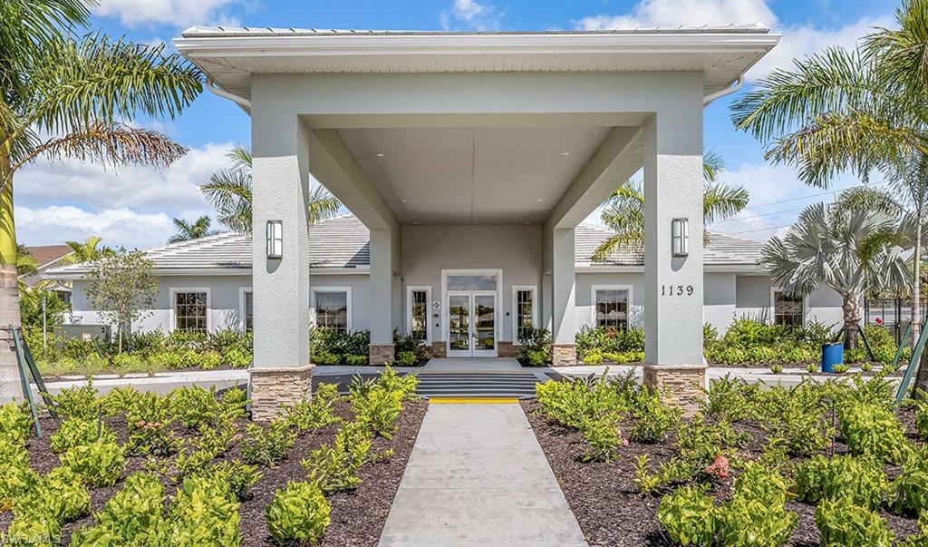 1067 Enbrook Loop Naples, FL 34114 - Photo 12 of 15 a view of a house with a yard