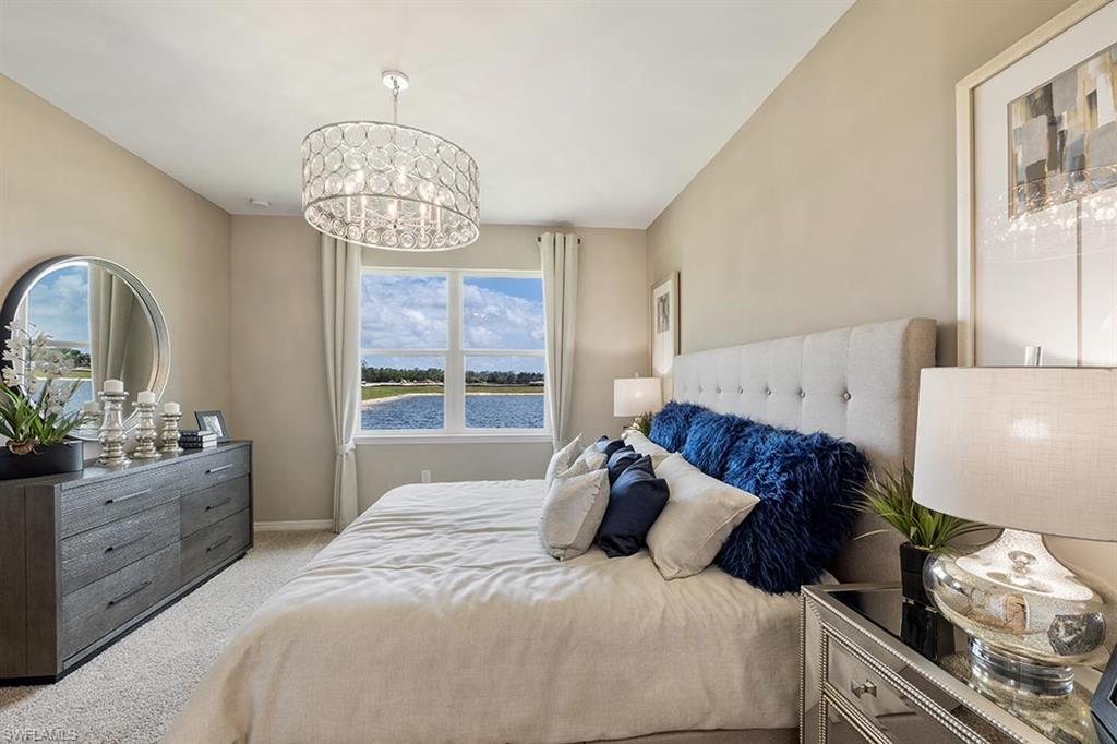 1067 Enbrook Loop Naples, FL 34114 - Photo 10 of 15 a bedroom with a bed and a chandelier