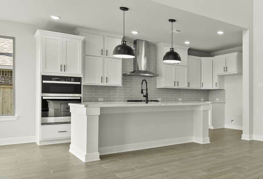 117 Beebalm Cove Georgetown, TX 78633 - Photo 5 of 22 a kitchen with stainless steel appliances granite countertop a sink a stove and a refrigerator